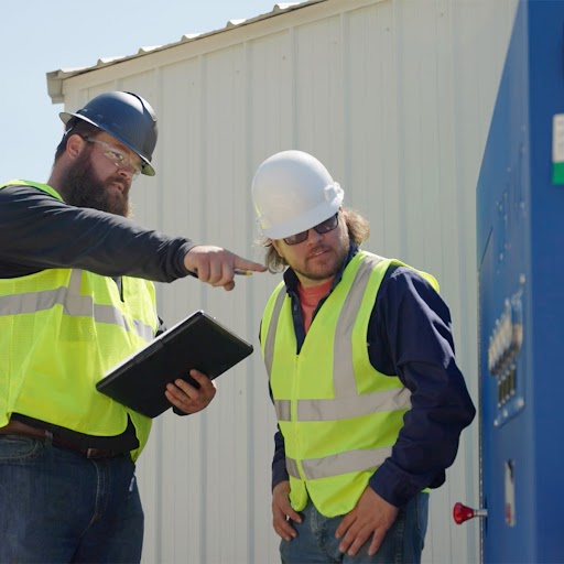 two men in hard hats on a job site 